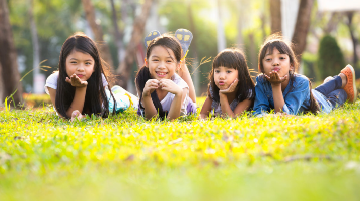 Anak-anak sedang bermain di taman dengan suasana cerah dan gembira.